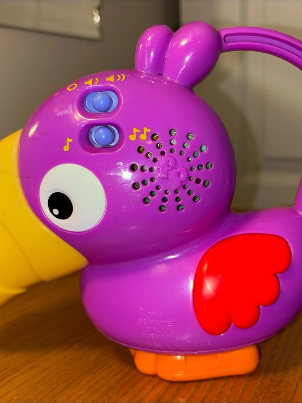 Fisher-Price Vibrant Purple Parrot Toy with Yellow Beak works great